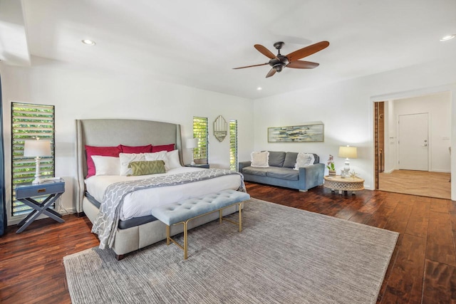 bedroom with dark hardwood / wood-style floors and ceiling fan