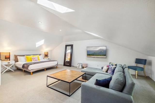 carpeted bedroom featuring vaulted ceiling with skylight