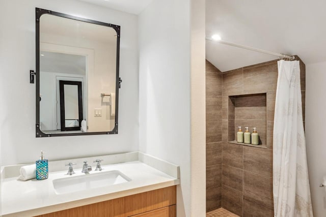 bathroom with a shower with shower curtain and vanity