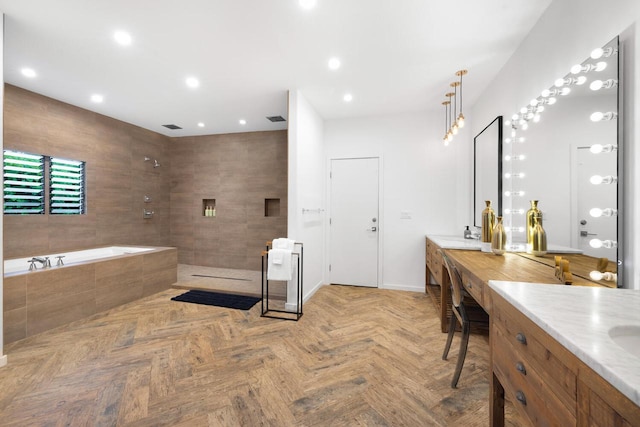 bathroom with vanity and shower with separate bathtub