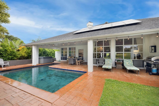 view of swimming pool featuring a patio and a grill