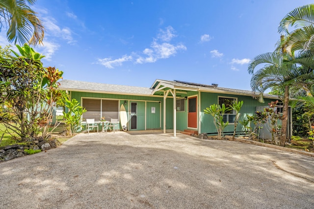 ranch-style home featuring solar panels