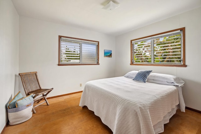 bedroom with light hardwood / wood-style flooring and multiple windows