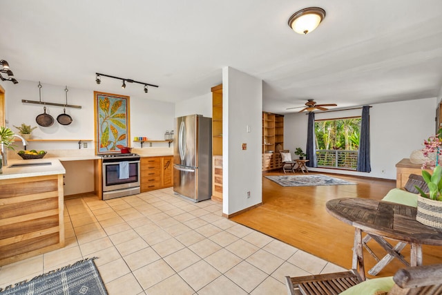 kitchen with ceiling fan, light hardwood / wood-style floors, sink, and appliances with stainless steel finishes