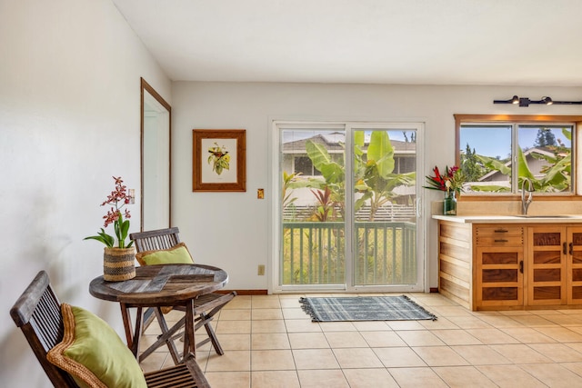 doorway featuring light tile patterned flooring and sink