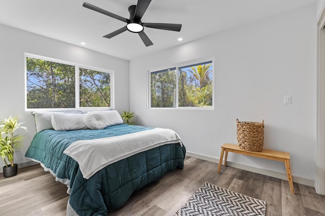 bedroom with hardwood / wood-style floors and ceiling fan