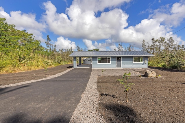 ranch-style home featuring a carport