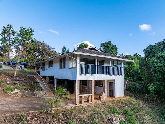 rear view of property featuring a balcony