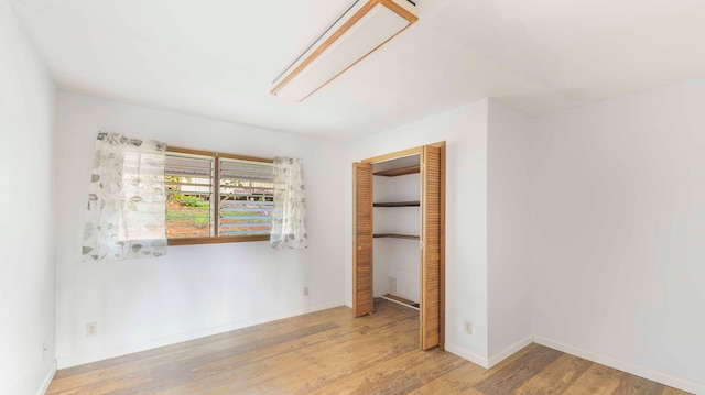 unfurnished bedroom featuring a closet and light hardwood / wood-style floors