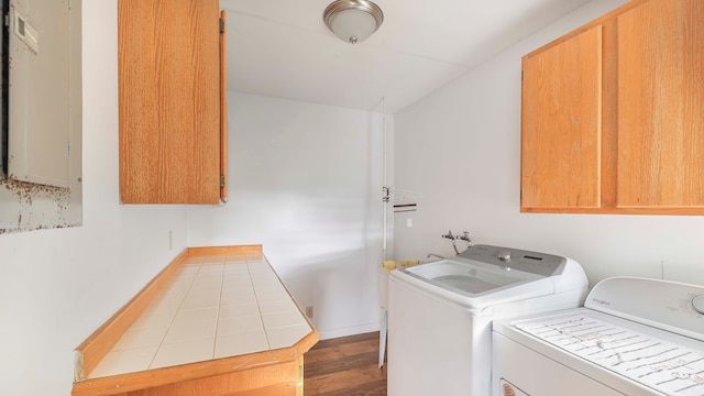 laundry room with cabinets, independent washer and dryer, and light hardwood / wood-style flooring