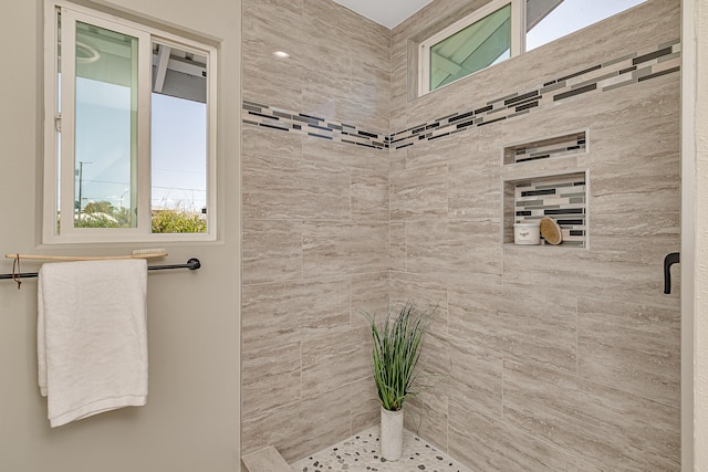 bathroom with a tile shower