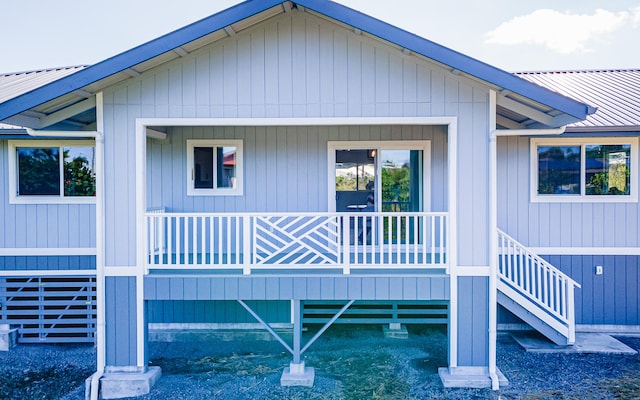 back of property with covered porch