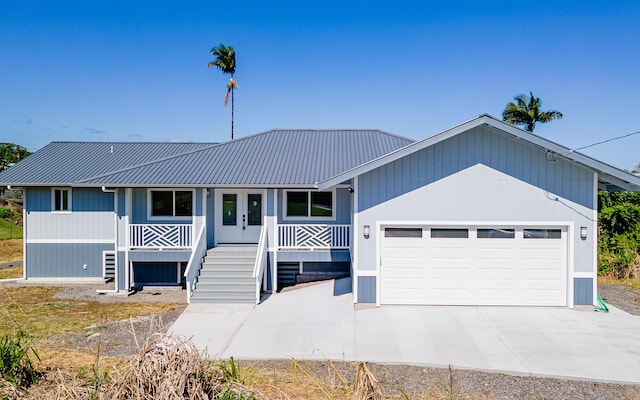 view of front of home featuring covered porch and a garage