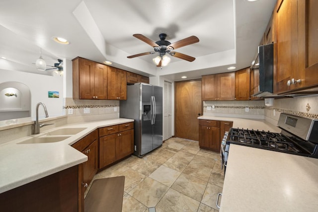 kitchen with ceiling fan, sink, backsplash, and appliances with stainless steel finishes