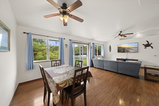 dining area with dark hardwood / wood-style floors and ceiling fan