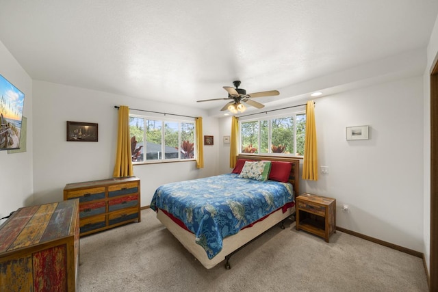 bedroom featuring light colored carpet and ceiling fan