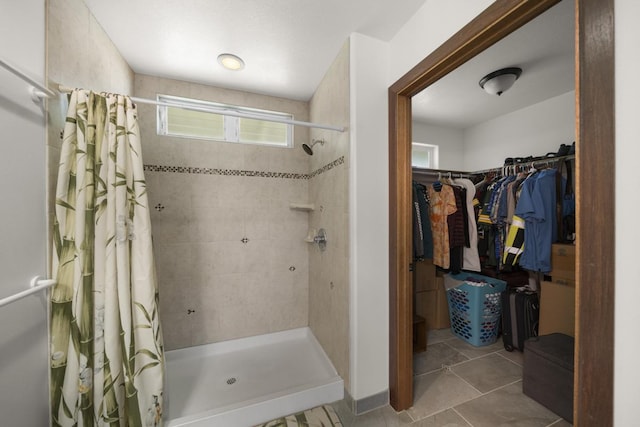 bathroom with tile patterned flooring and curtained shower