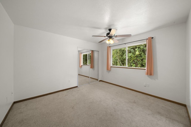 unfurnished room with ceiling fan and light colored carpet