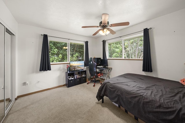 bedroom with carpet, ceiling fan, and a closet