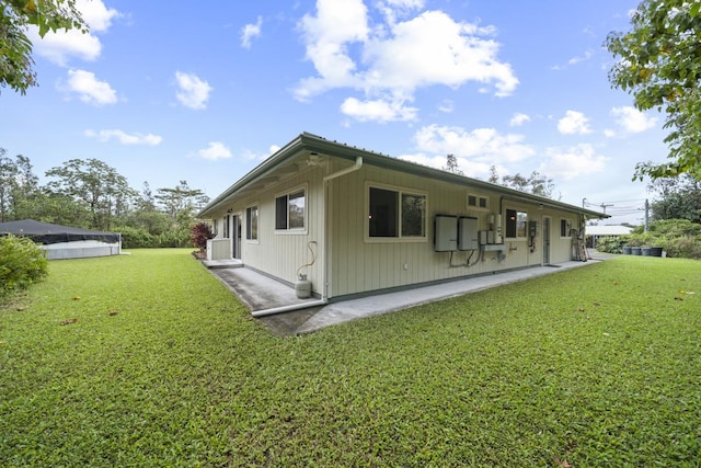 back of house with a lawn