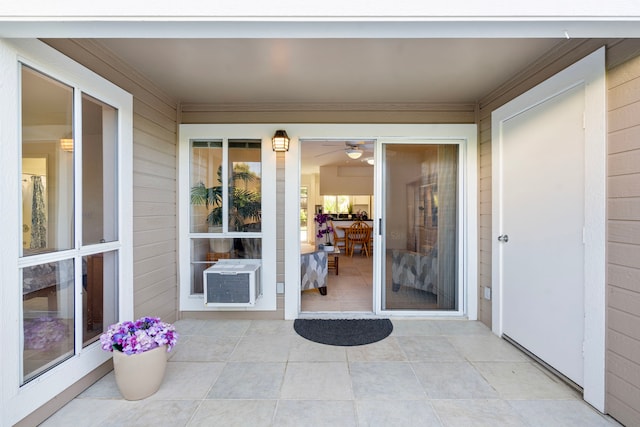 property entrance with cooling unit and a patio area