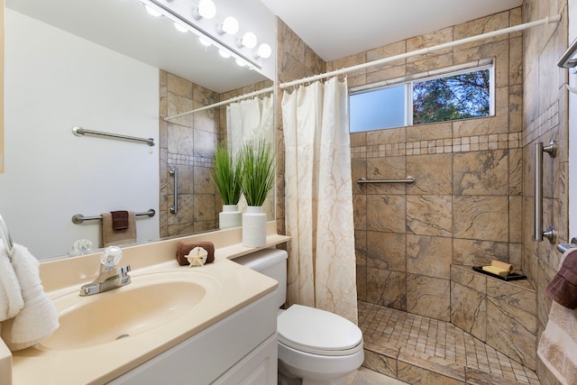 bathroom with a shower with curtain, vanity, and toilet