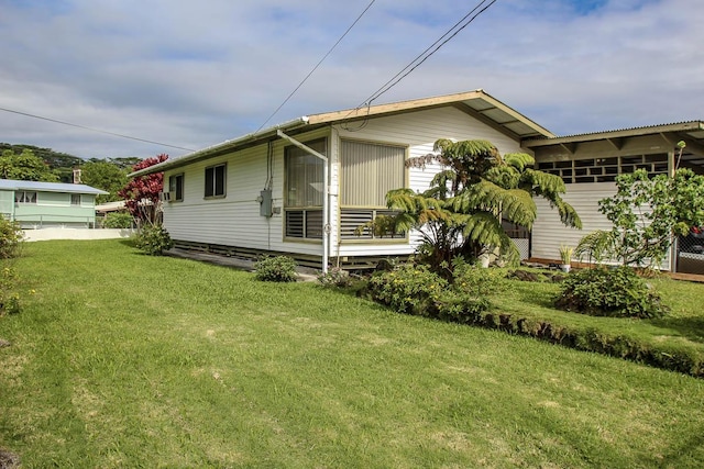 view of side of property with a lawn