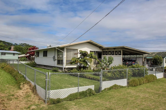 view of front of house with a front lawn and a carport