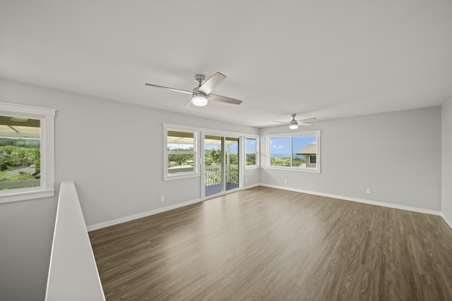 empty room featuring dark hardwood / wood-style flooring and ceiling fan