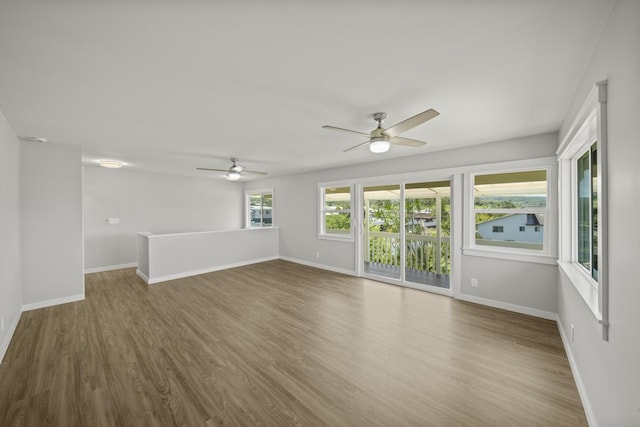 unfurnished room with hardwood / wood-style floors and ceiling fan