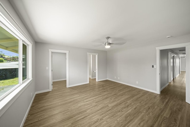 spare room with ceiling fan and dark wood-type flooring