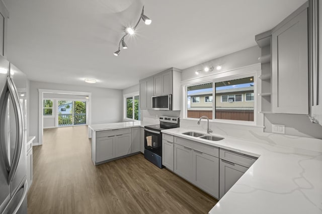 kitchen featuring stainless steel appliances, gray cabinets, and sink