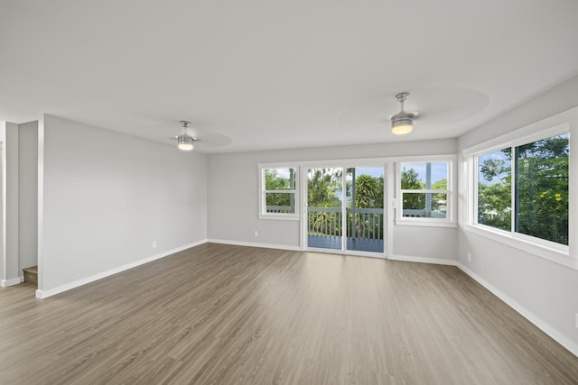 spare room featuring ceiling fan and hardwood / wood-style flooring