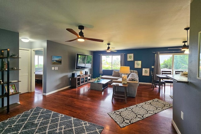 living room with dark hardwood / wood-style flooring and ceiling fan