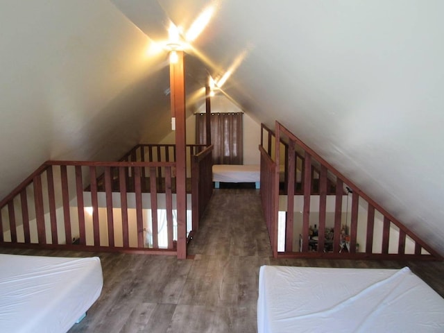 bedroom with dark hardwood / wood-style floors and vaulted ceiling