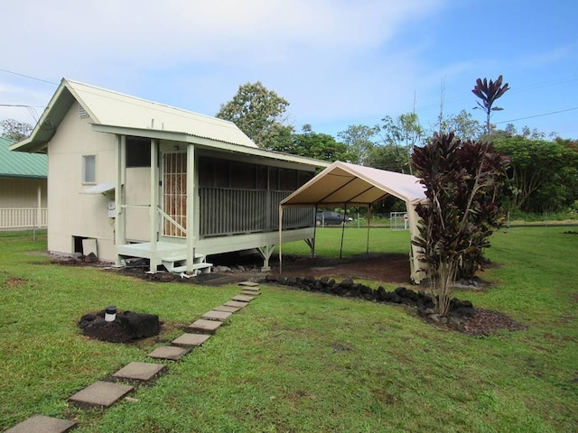 exterior space with a yard and a carport