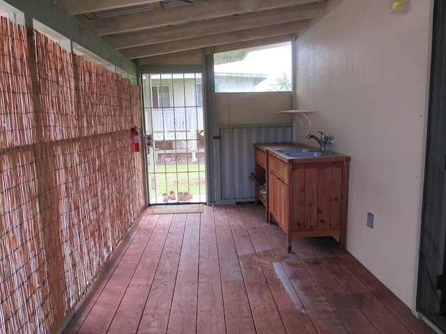 interior space featuring lofted ceiling with beams and sink