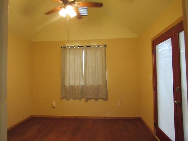 empty room featuring dark hardwood / wood-style floors, ceiling fan, and lofted ceiling