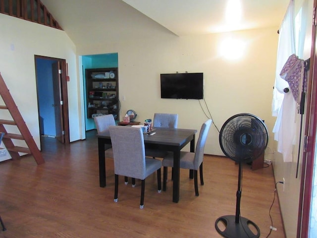 dining space featuring dark hardwood / wood-style flooring and lofted ceiling