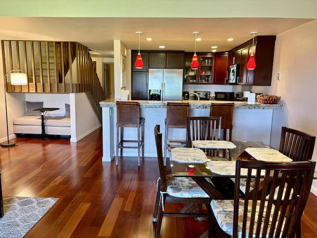 dining space with dark hardwood / wood-style floors