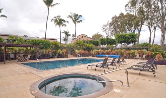 view of pool featuring a patio area, a community hot tub, and a pergola