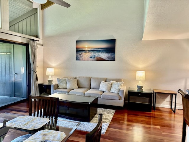 living room featuring hardwood / wood-style flooring, vaulted ceiling, and ceiling fan