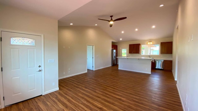 unfurnished living room featuring dark wood-type flooring, ceiling fan, and vaulted ceiling