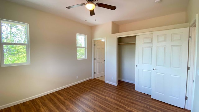 unfurnished bedroom featuring dark hardwood / wood-style flooring, a closet, and ceiling fan