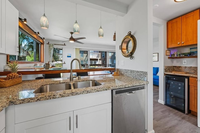 kitchen with dishwasher, sink, wine cooler, light hardwood / wood-style floors, and white cabinets