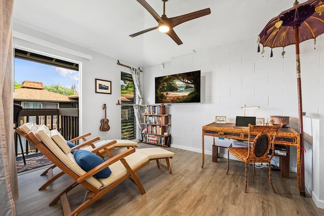 living area with hardwood / wood-style floors and ceiling fan