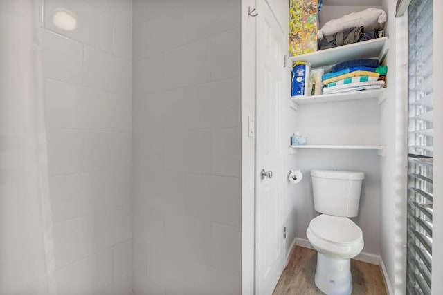 bathroom with toilet and hardwood / wood-style flooring