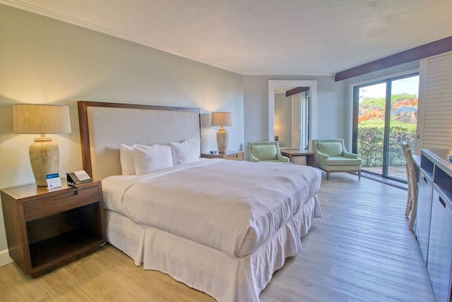 bedroom featuring access to outside, light hardwood / wood-style flooring, and crown molding