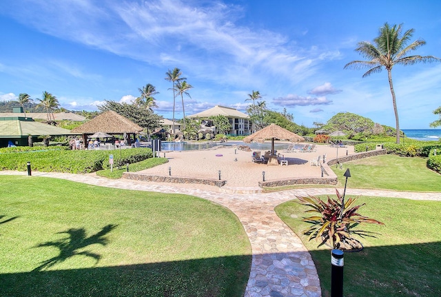 view of home's community featuring a gazebo, a water view, and a yard