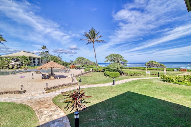 view of property's community with a gazebo, a yard, and a water view